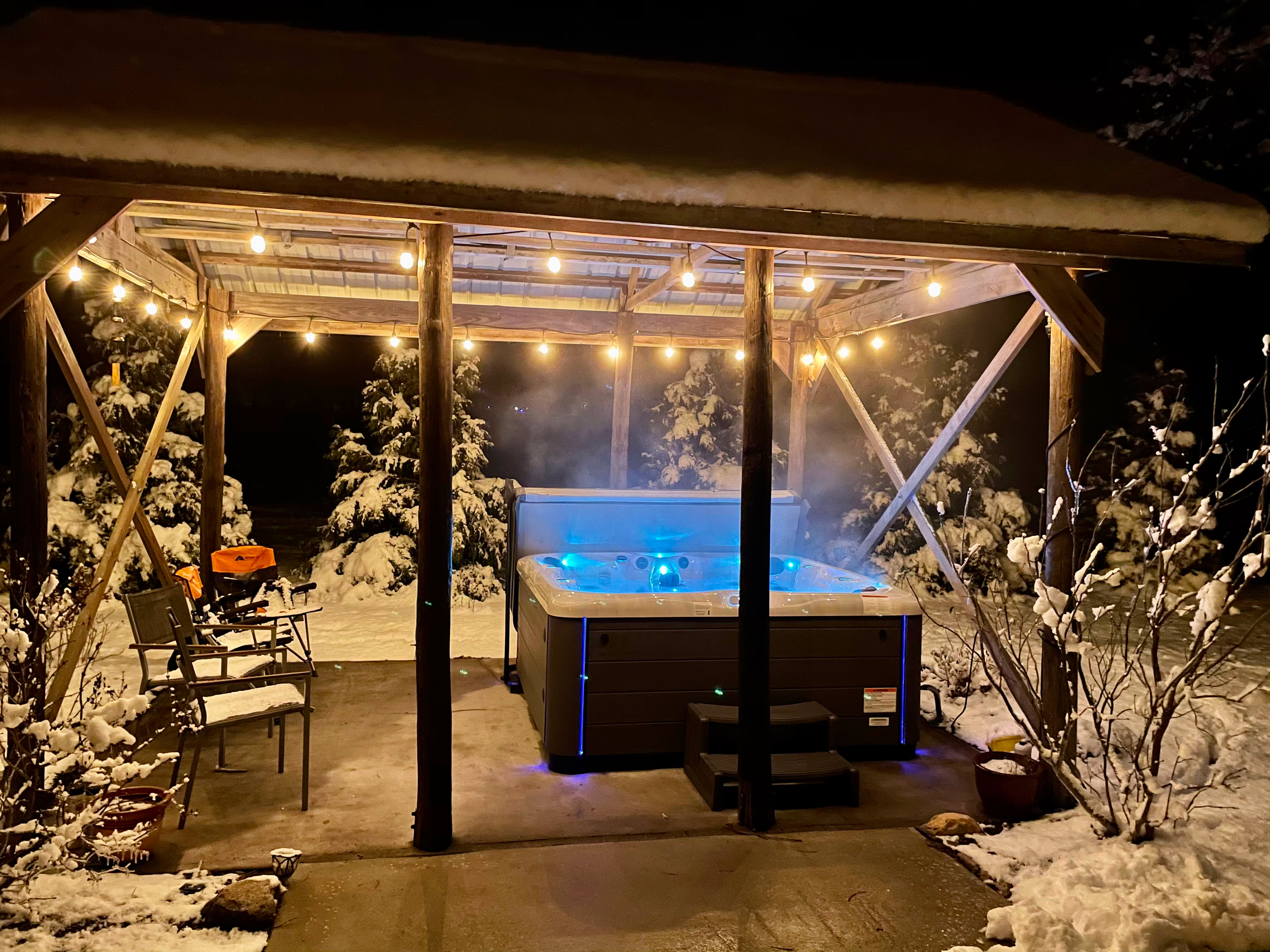 Used 2024 Twilight 8.25 hot tub under a pavilion at night